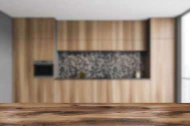 Ürününüz için ahşap masa gri duvarları, beton zemini ve lavabo ve ocakta yapılmış ahşap dolapları olan bulanık mutfağında. 3d oluşturma