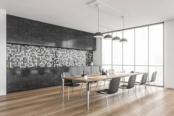 Grey and wooden minimalist kitchen, side view, dining table with chairs and dishes, window with city view. Long dining table in stylish modern kitchen, 3D rendering no people
