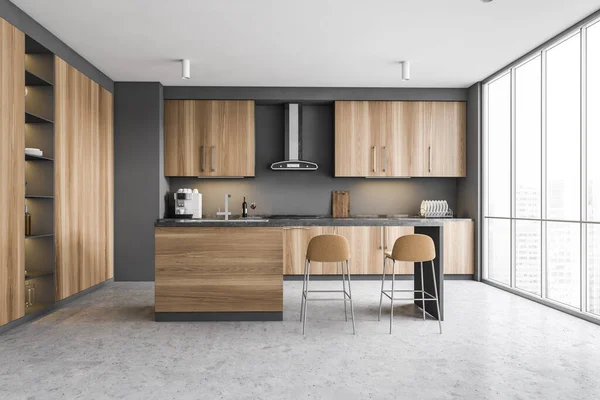 Interior of stylish kitchen with gray walls, concrete floor, wooden cupboards and bar with stools. 3d rendering