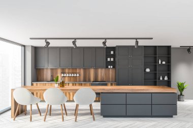 Beyaz ve gri duvarları, ahşap zemini, gri dolapları ve yemek masası olan şık bir mutfak. 3d oluşturma