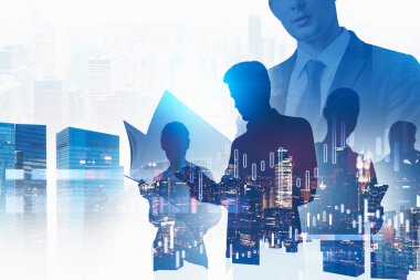 Young businessman with folder and his team standing in blurry city with double exposure of graphs. Toned image