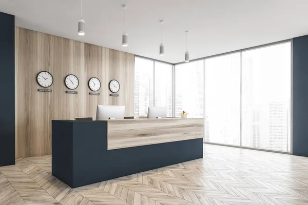 Blue and wooden reception room with desk, side view, computers and clocks on wooden wall. Minimalist reception desk on parquet floor in business office near window, 3D rendering no people