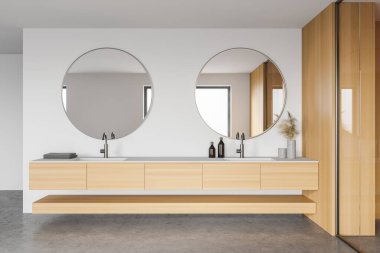 Modern banyo, beyaz ve ahşap duvarlar, beton zemin ve yuvarlak aynalı çift lavabo. 3d oluşturma