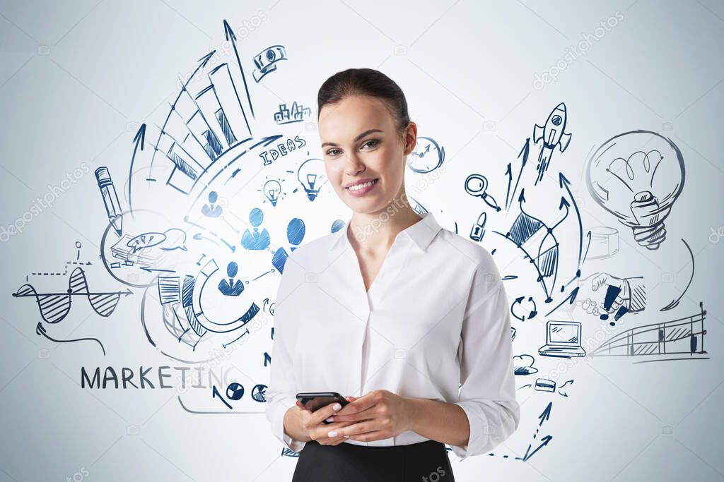 Young businesswoman with smartphone standing near concrete wall with business sketch drawn on it