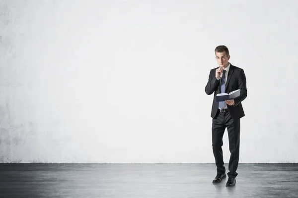 Full Length Portrait Young Businessman Book Standing Concrete Wall Concept — Stock Photo, Image