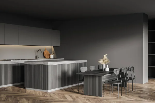 Corner of stylish kitchen with gray walls, wooden floor, wooden cupboard, dining table and island. 3d rendering