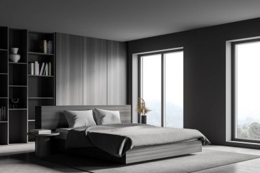 Modern ana yatak odasının köşesinde gri ve ahşap duvarlar, beton zemin, rahat kral yatağı, bir kitaplık ve bulanık manzaralı pencereler. 3d oluşturma