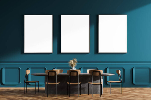Interior of minimalist dining room with blue walls, wooden floor, long oval table and black chairs. Three vertical mock up posters. 3d rendering
