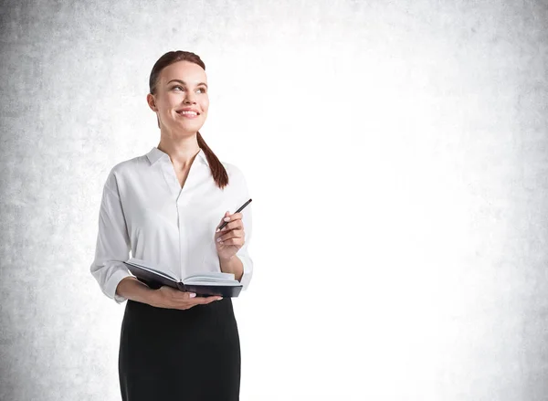 Portrait Smiling Young European Businesswoman Notebook Standing Cocnrete Wall Concept — Stock Photo, Image