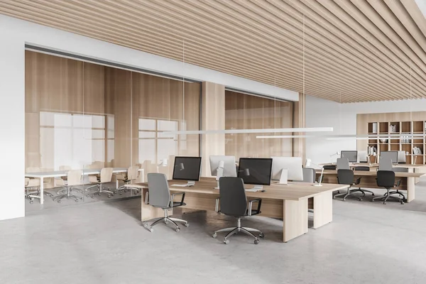 Beyaz ve ahşap duvarları, beton zemini, sıra sıra bilgisayar masaları ve solda toplantı odaları olan şık bir açık uzay ofisinin köşesi. 3d oluşturma