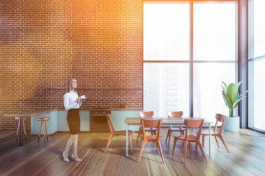 Çekici bir iş kadını gökdelen ofisindeki şirket mutfağında kahve içiyor. Modern mutfak seti ve çalışanlar için tesisler. Kafkas zarif modeli resmi olarak giyiniyor..