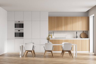Beyaz duvarları, ahşap parke zemini ve beyaz tezgahları olan modern mutfak. Yanında sandalyeler olan uzun bir masa. 3d oluşturma