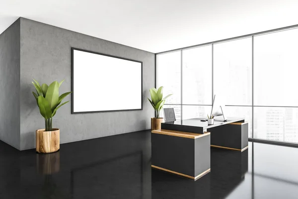 A CEO office interior with a wooden table, a computer standing on it, a framed poster on a gray wall. 3d rendering, mock up