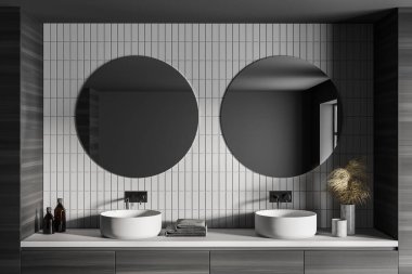 Gri banyoda iki beyaz lavabo ve ayna ve havlular. Gri banyodaki lavaboların minimalist tasarımı, beyaz tuğlalı duvar, 3D görüntüleme, insan yok.