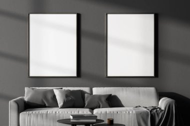 Modern arka planda iki tane poster çerçevesi, kanepeli siyah beyaz oturma odası. 3B görüntüleme