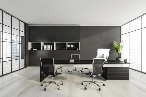 Dark wall office room with table and desktop computer, armchairs on white parquet floor. Shelf with papers on background, plant with city view. 3D rendering, no people