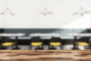 Ön planda ahşap masa, duvarda siyah ve sarı sandalyeler ve mavi kanepe olan bulanık bir kafe. Beton zemin ve kamu restoranının minimalist tasarımı. 3B görüntüleme