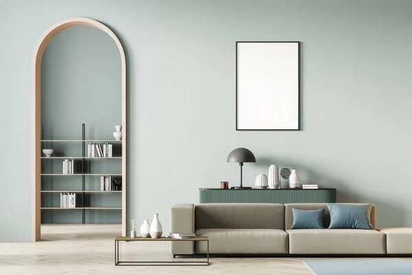 Modern mint color living room interior with arch and blank poster on wall. Beige sofa with light blue cushions, coffee table, light green chest of drawers, bookshelf. Parquet floor.3D rendering