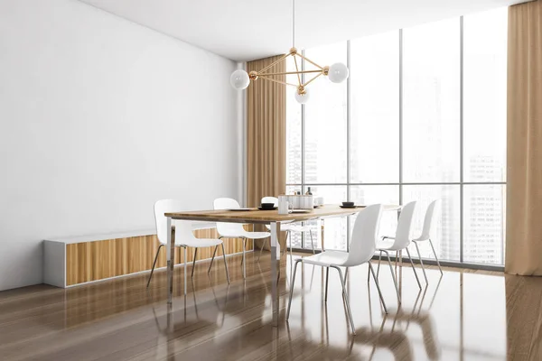 Wooden eating room interior with dishes on the table and white chairs on parquet floor, side view. Modern wooden design and panoramic windows with city view, 3D rendering no people