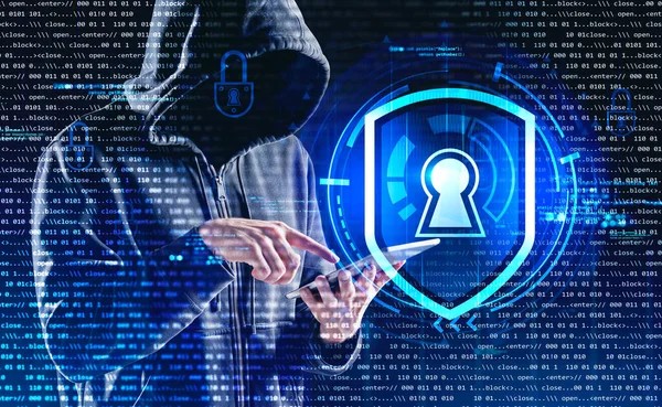 Hacker with hood and tablet in hands, double exposure with lock, script and binary code. Cyber attack in worldwide communication, hack of personal information