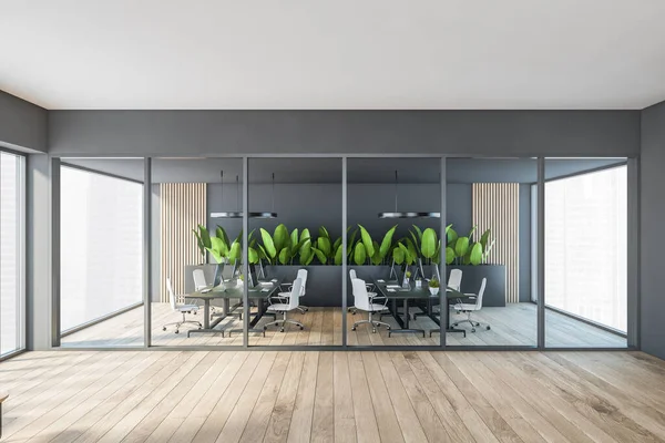 Dark modern minimalist office room interior with glass partition, desks with computer monitor, wooden parquet floor, panoramic window. Concept of contemporary business workplace. Close up view