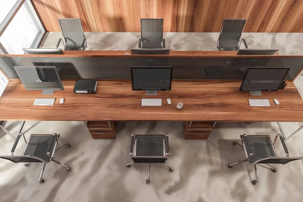 Top view of office interior with black armchairs and desktop computers on the table. Wooden manager workplace with modern minimalist furniture and window, 3D rendering