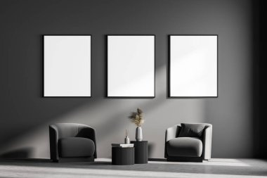 Modern oturma odası, iki koltuk ve küçük bir masa. Üç tanesi gri duvara çerçeveli posterler astı. Okuma ve rahatlama konsepti. İnsan yok. 3d oluşturma.