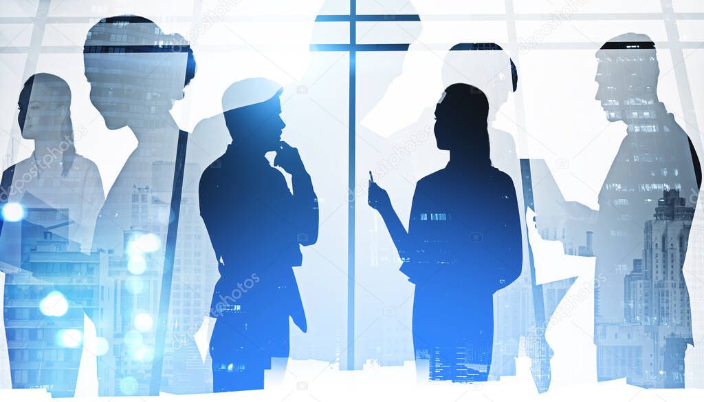 Silhouettes of diverse business people working together, toned image of office interior and skyscrapers with bokeh lights. Concept of young managers, partners cooperation