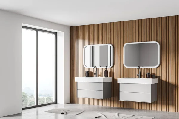 Light stylish bathroom interior with separate sinks and drawers with accessories, concrete floor. Side view, windows on countryside. 3D rendering no people