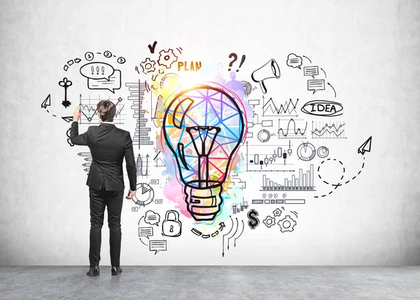 Office Man Black Suit Standing Colourful Lightbulb Drawing Network Graphs — Stock Photo, Image