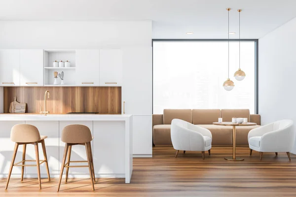 White bar counter with beige stools standing in modern kitchen with white and wooden walls, wooden floor and living room with sofa and armchair in the background. Front view. 3d rendering