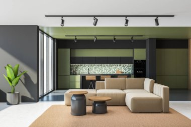 Yeşil ve gri duvarları, beton zemini, mozaik duvarın yanında duran tabureleri ve rahat bej koltuğu olan şık bir oturma odası ve mutfağı var. 3D görüntüleme, bulanık şehir manzarası