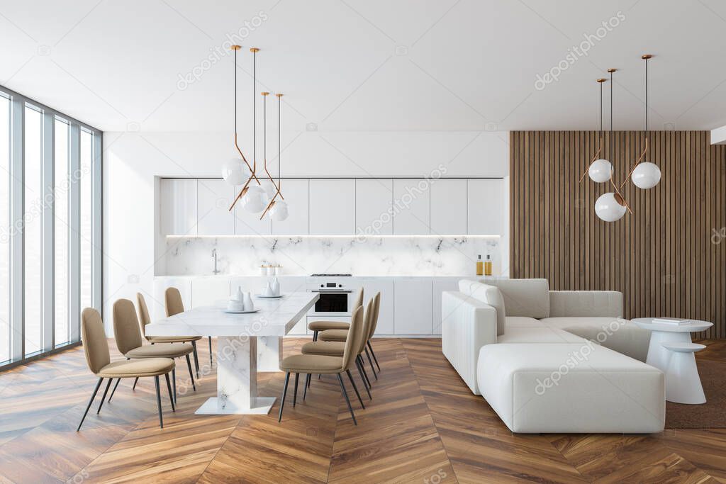 Interior of stylish kitchen with white and wooden walls, wooden floor, white countertops and cupboards and long white marble table with beige chairs. Long white sofa and coffee tables. 3d rendering