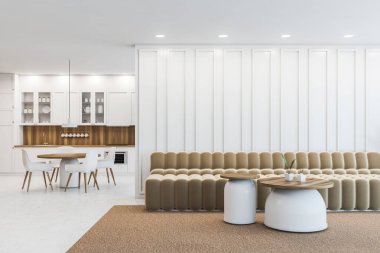 Beyaz duvarları olan şık ofis bekleme odasının içinde iki yuvarlak sehpası ve arka planda küçük ofis mutfağı olan bej bir kanepe. 3d oluşturma