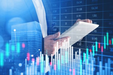 Ofisteki adam tablet ekranda yazıyor, borsa değişiklikleriyle dijital arayüz. Finansal tablolarla ve büyüyen şamdanlarla çifte ilgi. Çevrimiçi ticaret kavramı