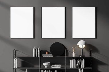 Üzerinde lamba ve yuvarlak ayna bulunan klasik beyaz kitap rafları ve üç dikey poster çerçevesi olan gri oturma odasını, çalışma odasını veya ev kütüphanesini kapatın. 3d oluşturma