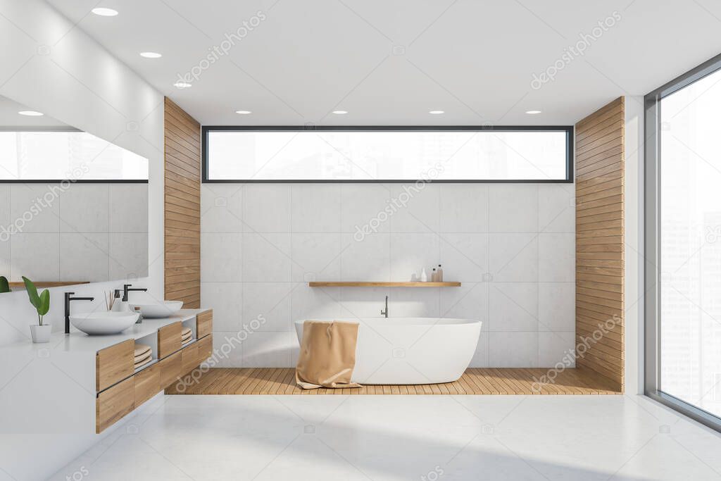 White bath in bathroom, standing on the wooden surface. Narrow horizontal and panoramic windows. Marble flooring. Drawers with two sinks and mirror on the wall. 3d rendering