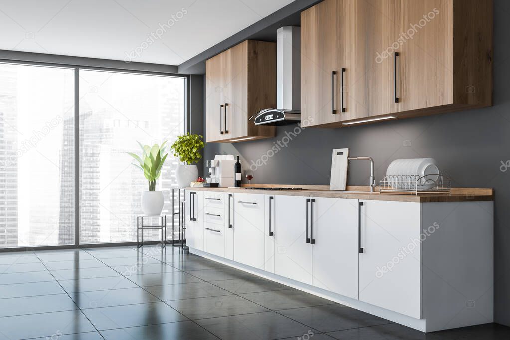 Corner of panoramic city interior with kitchen. Wooden upper cabinets and worktop. White drawers at the bottom. Flower stands with plants at the window. Tiling floor. 3d rendering