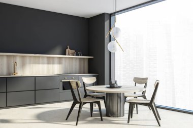 Koyu gri panoramik mutfak alanının köşesinde açık ahşap masa, sandalyeler ve dolabın su sıçraması. Orijinal avize, koyu gri duvarlar ve beton döşeme. 3d oluşturma