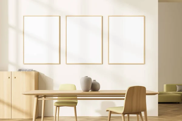 Three banners on the wall in the light yellow living room interior with table, two chairs and sideboard. Wooden details and greenish shades of yellow. Sofa at the back. Parquet. Mockup. 3d rendering