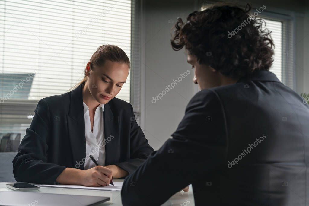 Businessman and businesswoman in formal suits on job interview. Looking for new talented candidates for corporate company. Recruitment department. Lady is taking notes