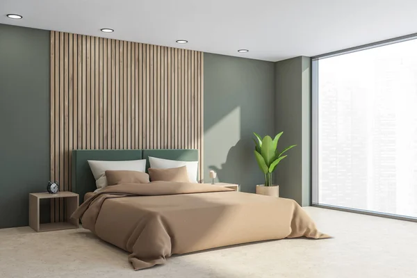 Interior with bed, sideboard, light moss green walls and headboard of the bed with beige sheets, wooden details, side tables, plant, light concrete flooring and panoramic view. 3d rendering