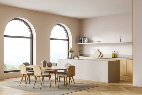 Studio kitchen with arch windows, pinky white walls, wooden and stone details. Parquet floor with carpet. Interior corner with doulbe sided cabinet and table with chairs. 3d rendering