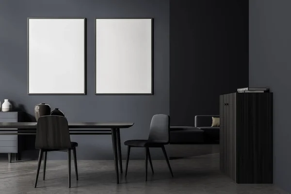 Banners on the wall in the dark grey living room interior with table, two chairs and wooden sideboard. Sofa at the back. Concrete floor. Mockup. 3d rendering