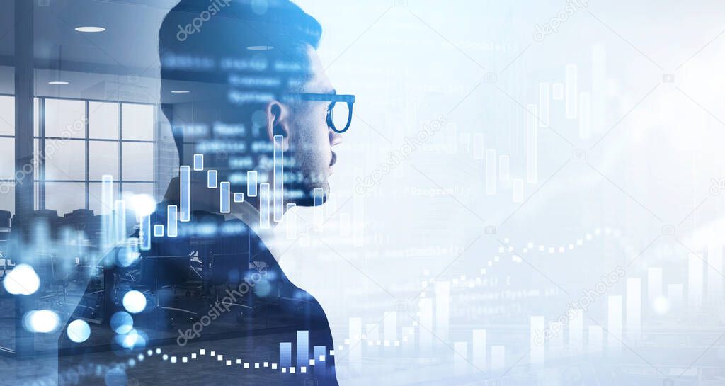 Over the shoulder shot of businessman in glasses and suit looking at financial graphs, candlestick, analytics for investment solution. Double exposure. Modern panoramic office interior on background