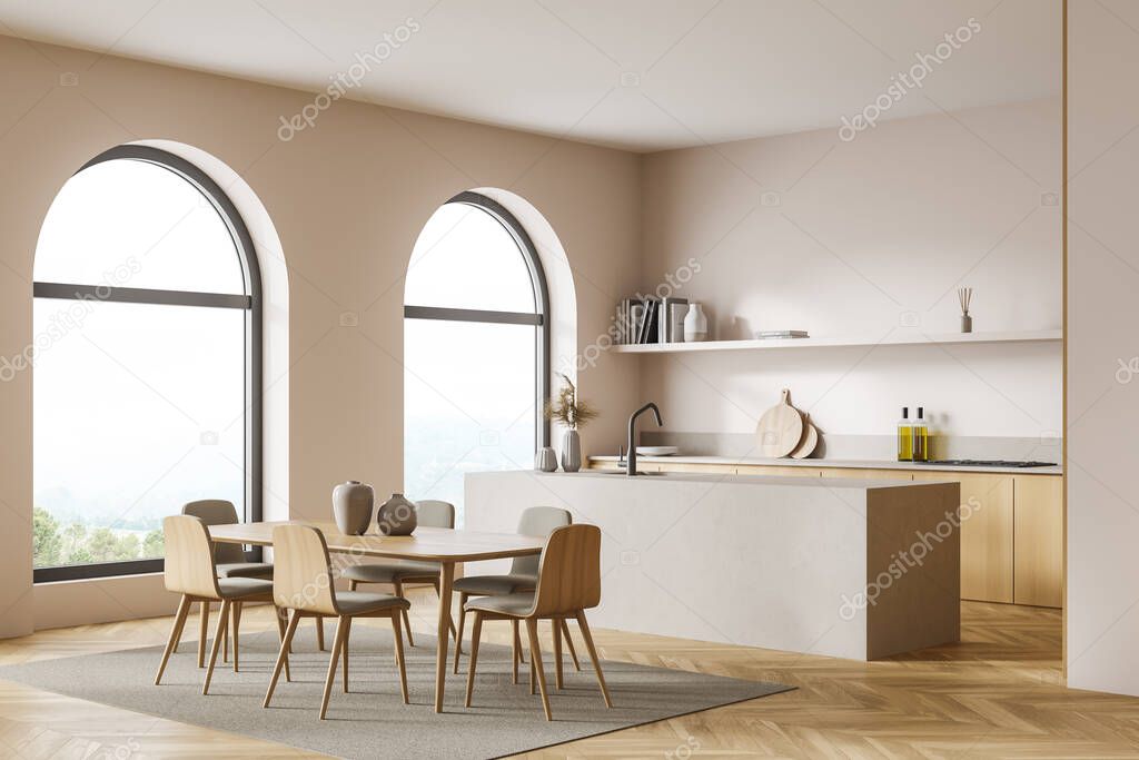 Estudio cocina con ventanas de arco, paredes de color blanco rosado,  detalles de madera y piedra. Suelo de parquet con alfombra. Esquina  interior con gabinete de doble cara y mesa con sillas.
