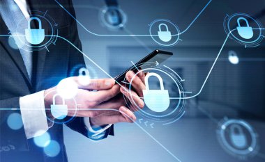 Businessman in formal suit is browsing the Internet in smartphone. Blue glowing information protection padlock icons. Concept of cyber security and data storage