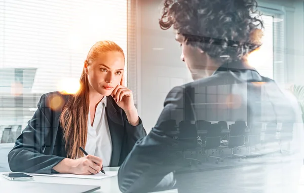 Businessman and businesswoman in formal suits on job interview. Looking for new talented candidates for corporate company. Recruitment department. Lady is taking notes. Double exposure, meeting room