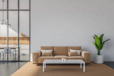 Beyaz ve bej oturma alanı boş duvar, kanepe, sehpa, halı ve kapalı alan bitkisi. Beton zemin. Arka planda mutfak içi olan minimalist bir kavram. 3d oluşturma