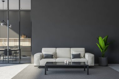 Açık bej kanepe, sehpa, halı ve ev bitkisi kullanarak gri oturma alanı tasarımı. Açık beton zemin. Arka planda mutfak içi olan minimalist bir kavram. 3d oluşturma